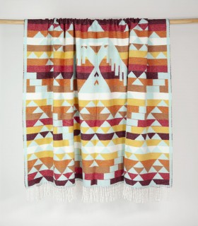 Camper blanket Huitzilin Turquoise hanging on a bar