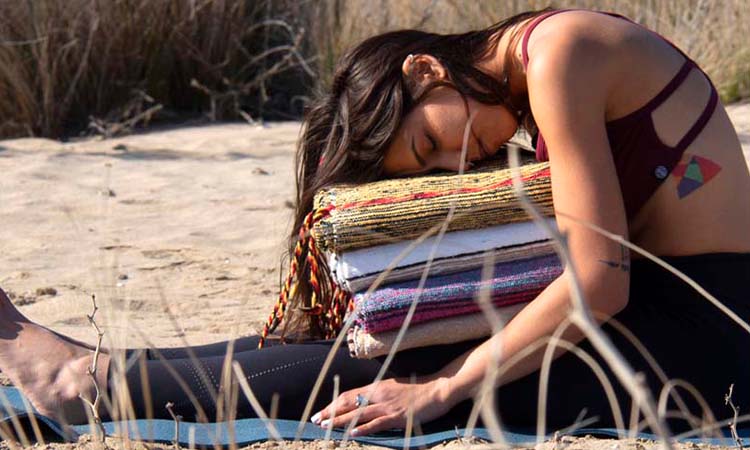 Girl doing restorative yoga with blanket